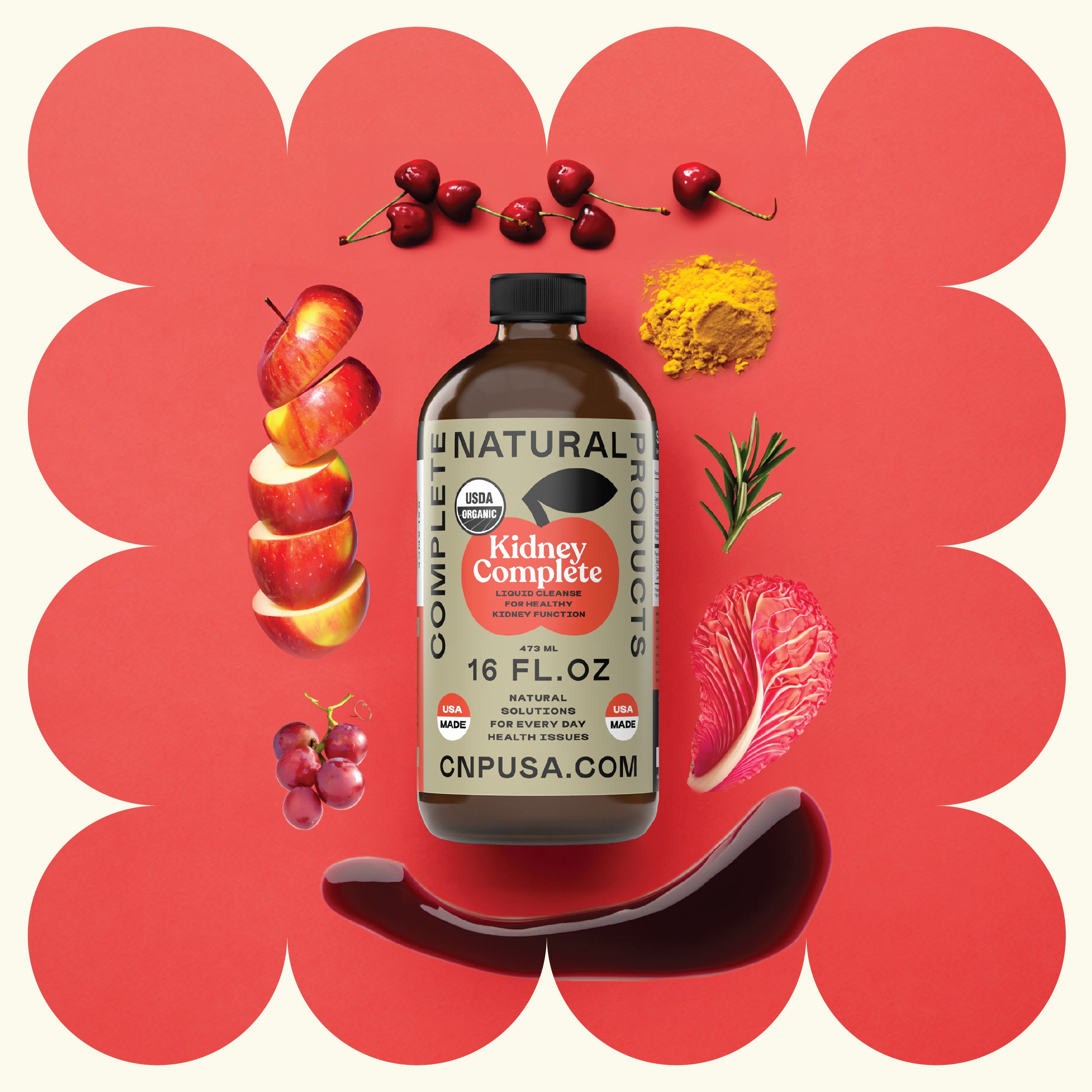 A 16oz glass bottle of CNPUSA Kidney Complete, highlighted with Chanca Piedra for kidney health, is displayed among cherries, apples, turmeric, rosemary, red cabbage, grapes, and a splash of liquid on a red and cream patterned background.