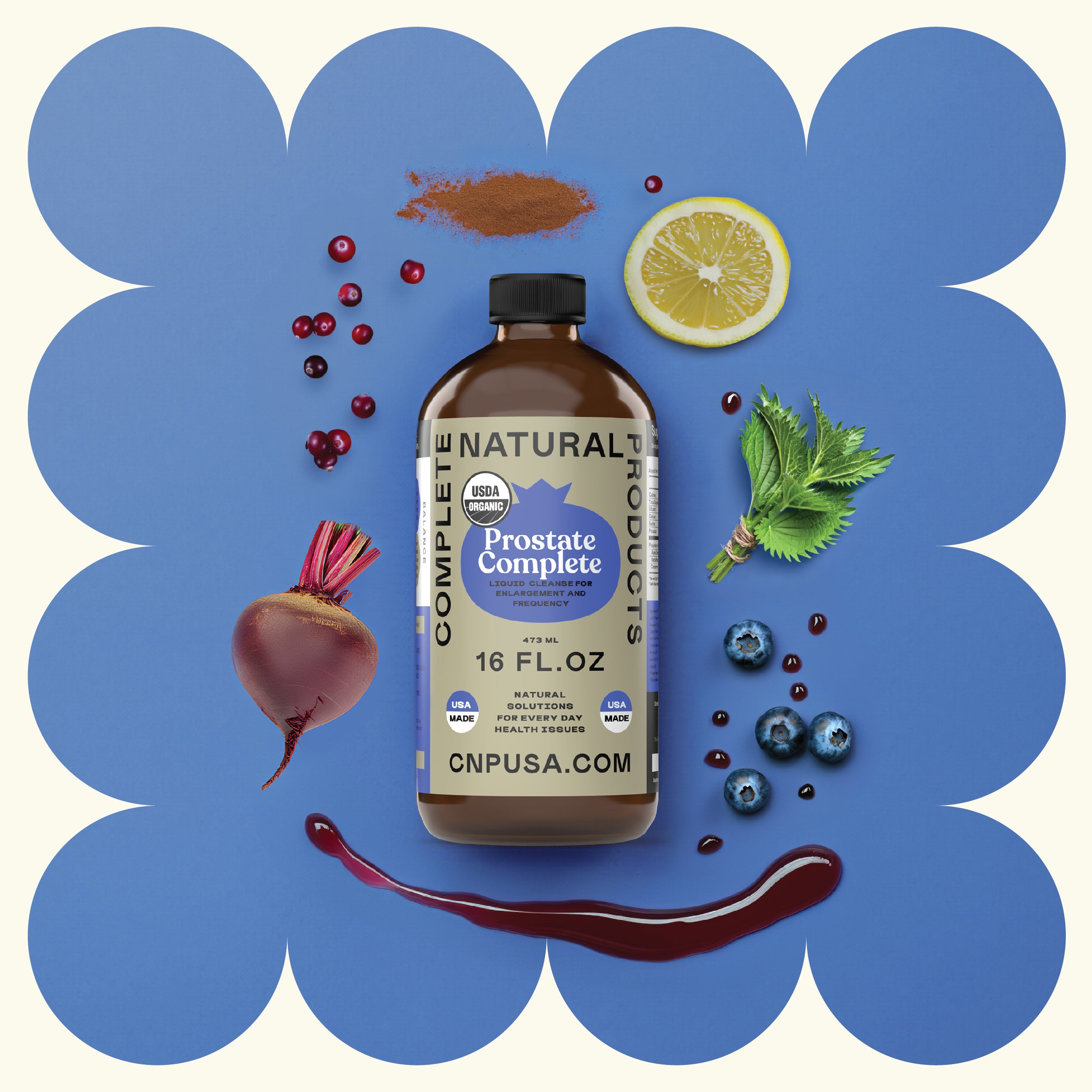A 16oz glass bottle of CNPUSA Prostate Complete is set on a blue background with a scalloped cream border, surrounded by lemon slice, blueberries, cranberries, beet, leafy greens, cocoa powder, and purple liquid.